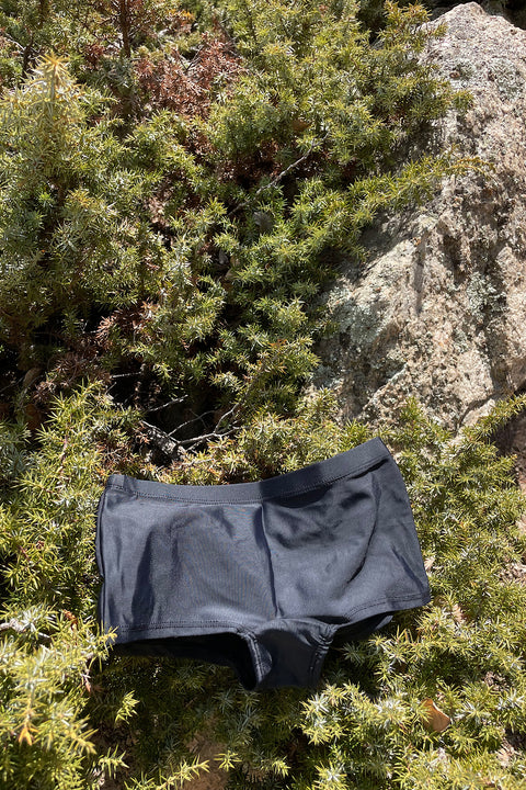 Black sporty swim shorts made with recycled nylon.