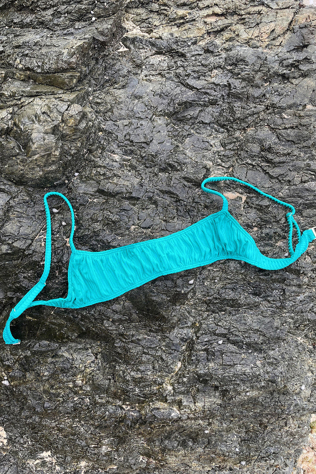 Ribbed green sports bra bikini top by sustainable swimwear company.