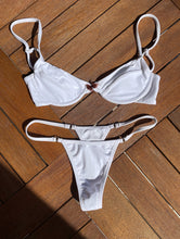 Load image into Gallery viewer, White ring bikini bottoms made from recycled materials.
